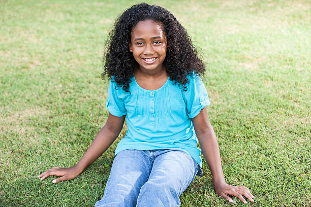 istock Girl sitting on grass 480629525