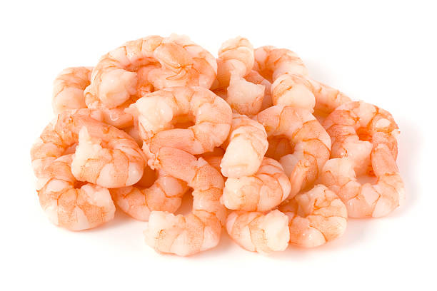 Cooked and peeled king prawns on a white backgound