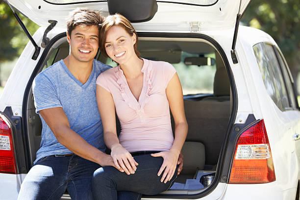 istock Couple Sitting In Trunk Of Car 480631161