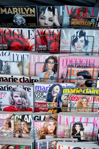 Athens, Greece - March 21, 2014 Stack of magazines for women on a newsstand at Athens Omonoia Square, Vogue Elle Marie Claire Lofficiell Tatler Glamour Cosmpopolitan