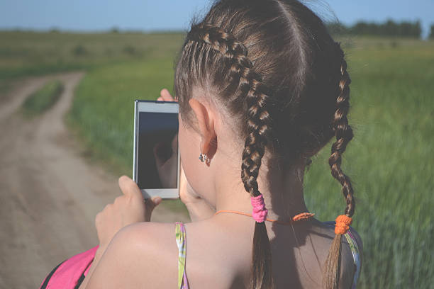 istock Little girl walking with gadget 480632140