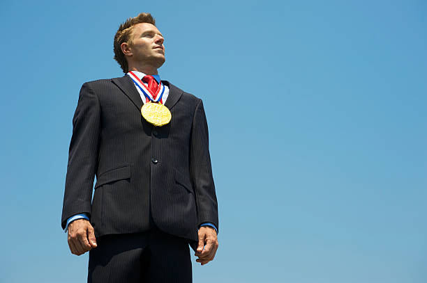 istock Proud Businessman Stands with Gold Medal 480632495