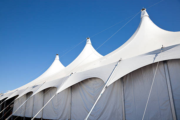 Large White Marquee Tent with clear blue sky Top of a large white event marquee tent for entertainment, party or exhibition. pavilion photos stock pictures, royalty-free photos & images
