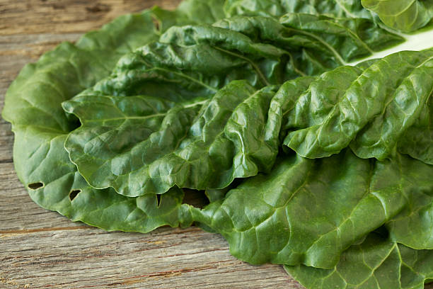 istock Organic collard greens on rustic wood surface 480635495