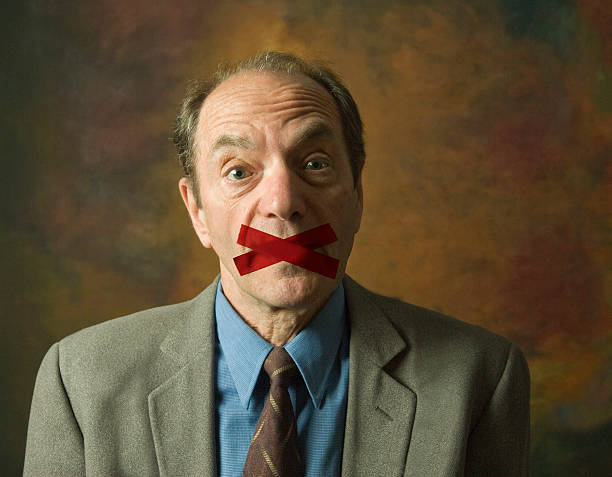 istock man with tape across mouth 480636041