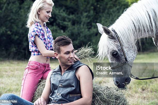 Cheerful Couple And A Horse Stock Photo - Download Image Now - Adolescence, Adult, Agricultural Field