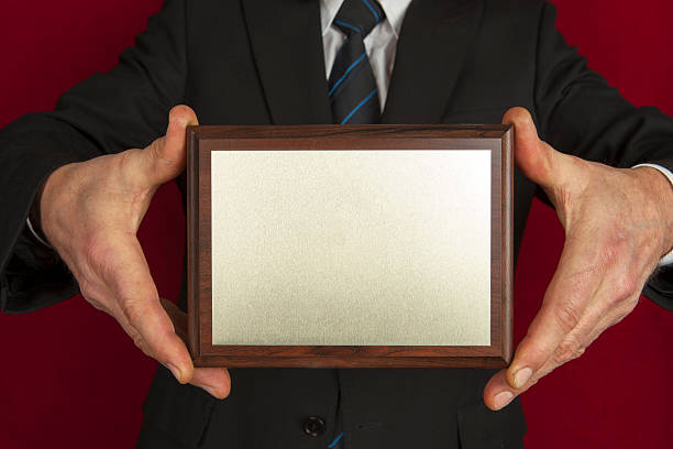 Memorial plaque in the hands of men