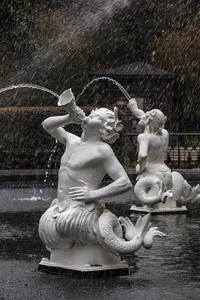 White painted cast iron satyrs spray water in Forsyth Park