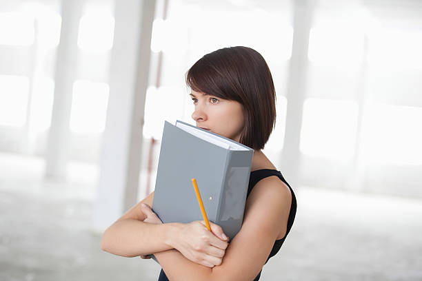 istock Thoughtful Businesswoman With Ring Binder 480639791