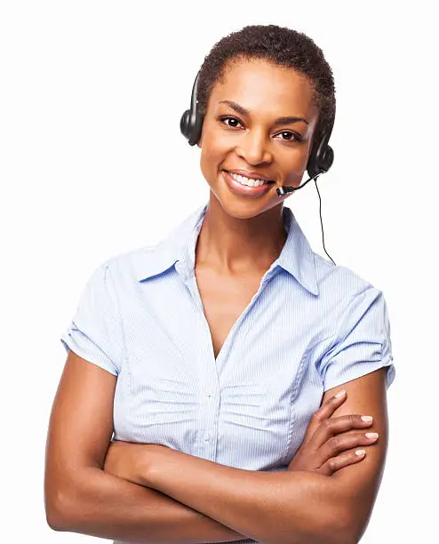 Portrait of a friendly African American female helpdesk operator smiling with arms crossed. Horizontal shot. Isolated on white.