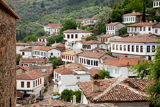 Houses, bungalows in Thera and Oia, two small villages on the crater rim of the Greek island of Santurini in the Aegean Sea in the warm evening or morning light of the sun