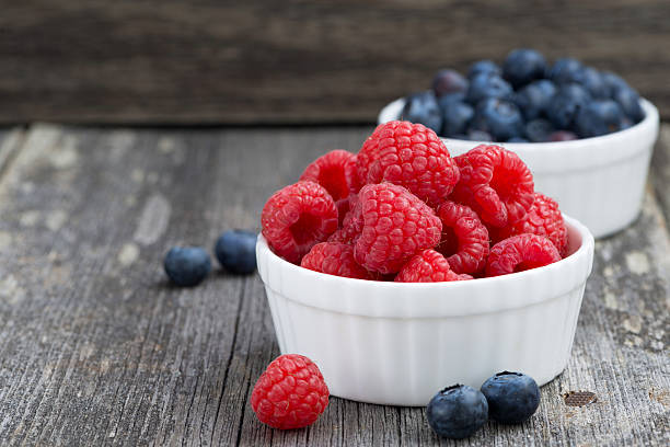 istock seasonal berries - raspberries and blueberries in bowls 480643830