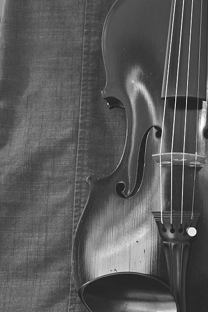 istock Antique violin closeup against gray fabric background 480650020