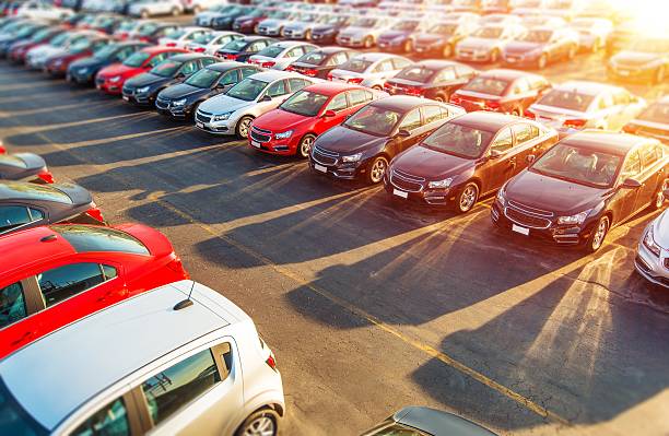 Dealer New Cars Stock Dealer New Cars Stock. Colorful Brand New Compact Vehicles For Sale Awaiting on the Dealer Parking Lot. Car Market Business Concept. parking photos stock pictures, royalty-free photos & images