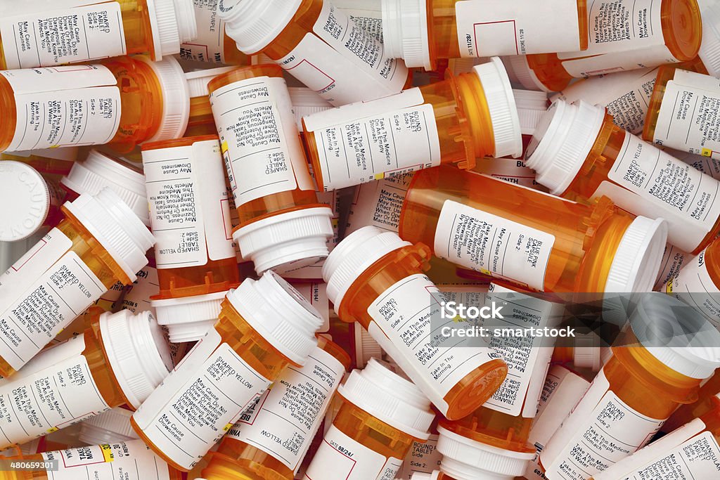 Dozens of Prescription Pill Bottles Dozens of prescription medicine bottles in a jumble. This collection of pill bottles is symbolic of the many medications senior adults and chronically ill people take. Prescription Medicine Stock Photo