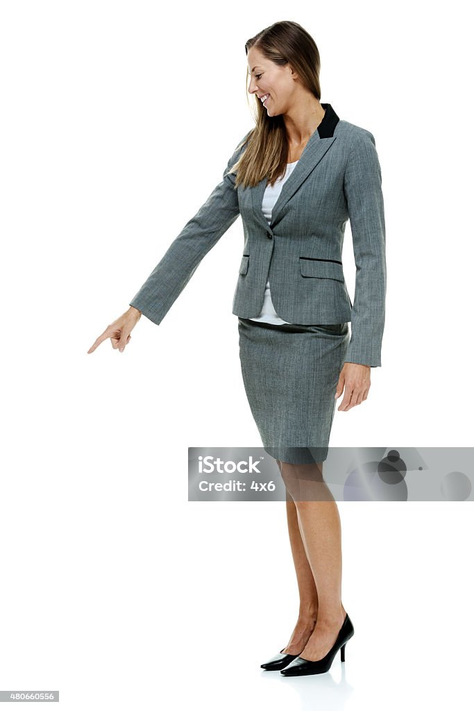Smiling businesswoman pointing Smiling businesswoman pointinghttp://www.twodozendesign.info/i/1.png 20-29 Years Stock Photo