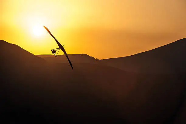 An ultralight plane against sunset sky ,hang Glider Pilot Launching ,Nikon D3x