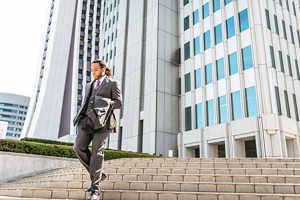 istock business man descending the steps on the city 480663634