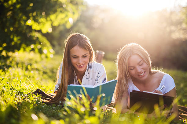 istock Young smiling women relaxing in nature and studying. 480663812