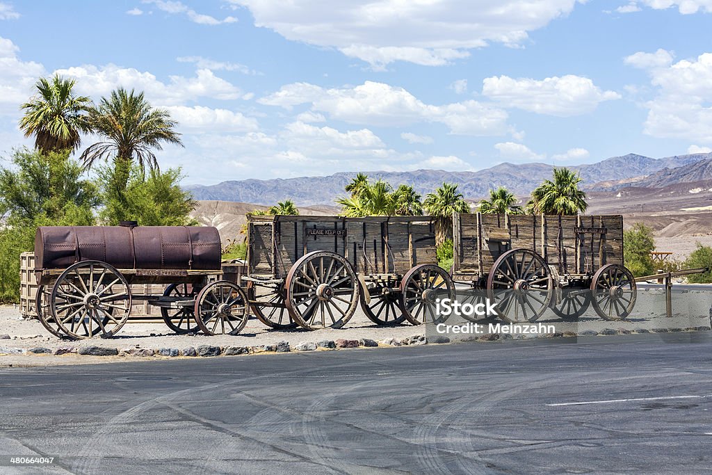 old waggons in the Death valley old waggon at the entrance of the Furnance Creek Ranch in the middle of Death Valley, with these wagons the first men crossed the death valley in the 19th century Cowboy Stock Photo