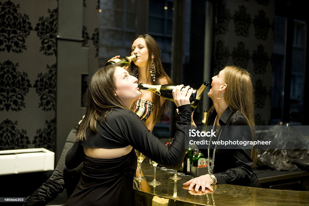 Drinking Champagne From Bottle Three women drinking champagne from bottle, canon 1Ds mark III Adult Stock Photo