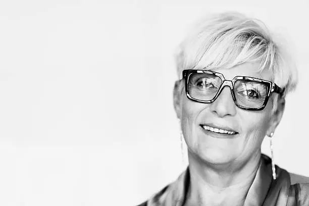 Portrait of senior manager woman in office, black and white.