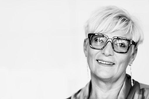 Portrait of senior manager woman in office, black and white.