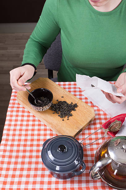 Young girl making tea in kitchen