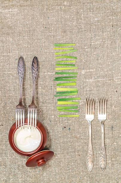 istock Chopped onion, sour cream pot, and four forks 480680171