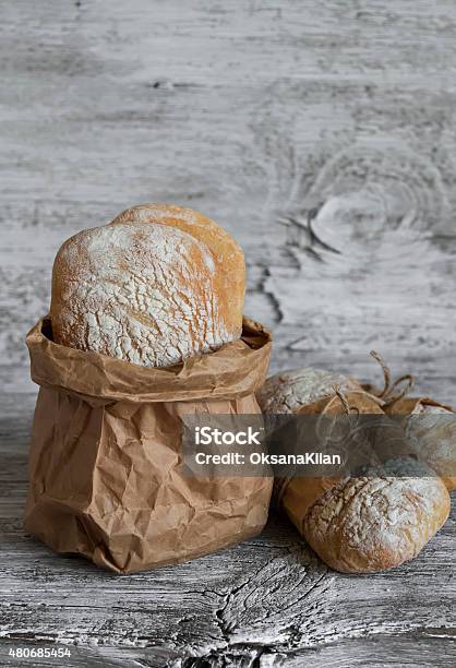 Homemade Rustic Bread On A Light Wooden Surface Stock Photo - Download Image Now - 2015, Bagel, Baguette