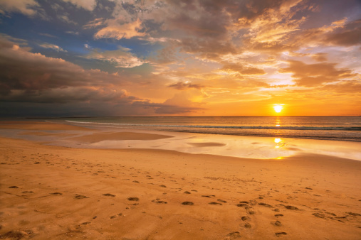 Tropical beach in ebb time on sunset background