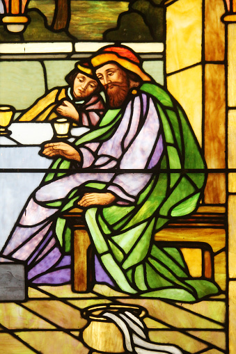 Two en are portrayed in this religions stained glass panel.