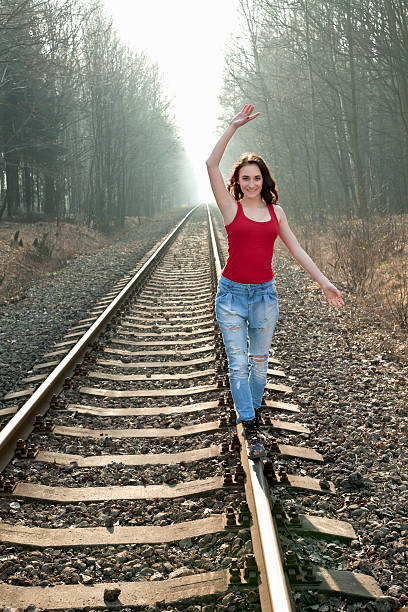 istock Young girl balancing on rails. 480691917