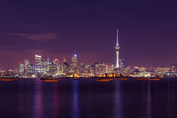 Auckland City at night Long exposure of New Zealand's biggest city at night time, beautiful city colours reflecting on the Waitemata harbour. auckland stock pictures, royalty-free photos & images