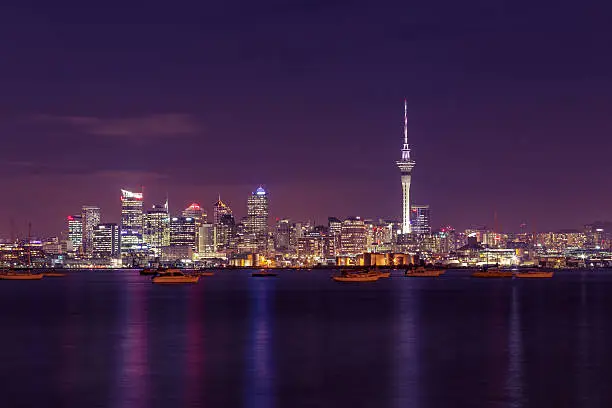 Long exposure of New Zealand's biggest city at night time, beautiful city colours reflecting on the Waitemata harbour.