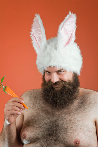 Sarcastic bearded fat man wears silly bunny ears