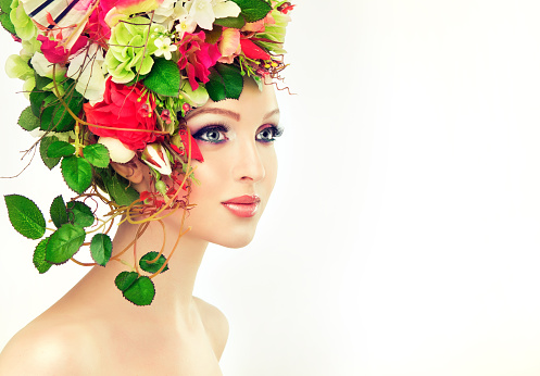 Spring woman. Beauty model girl with colorful flowers hairstyle