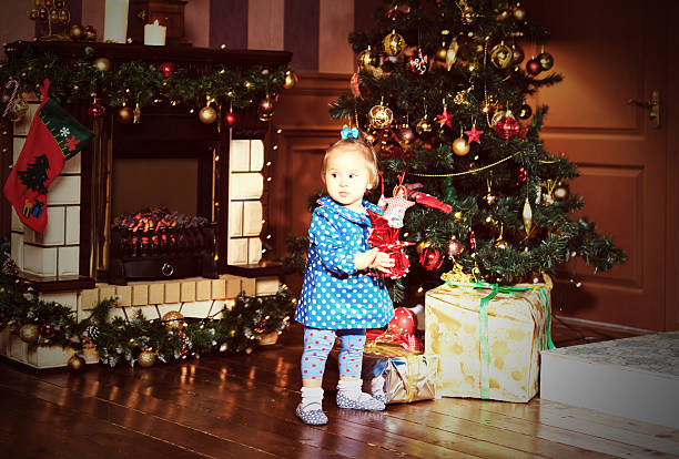 istock little girl with presents at christmas 480695380