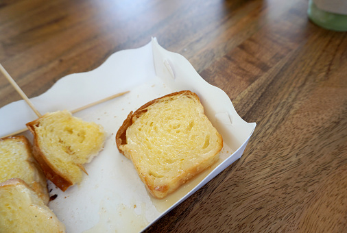bread and butter toast in the paper box on timber table