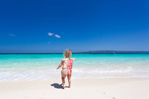 istock Happy little girl on the beach 480697337