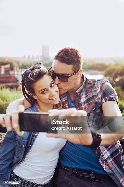 Happy Couple Taking Selfies Stock Photo - Download Image Now - 2015, Adult, Adults Only
