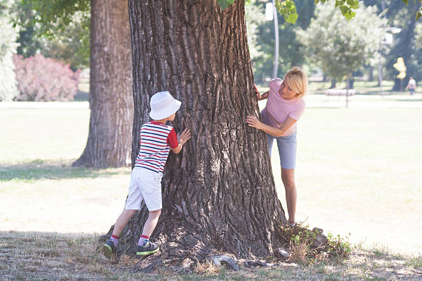 istock Blond woman and child play around a tree 480699188