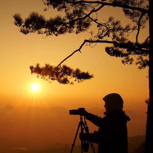istock Silhouette photographer sun set time 480702960