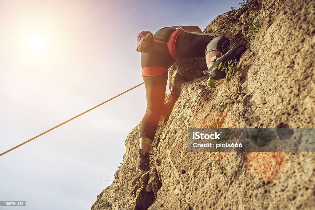 Female rock climber freeclimbing Achievement Stock Photo