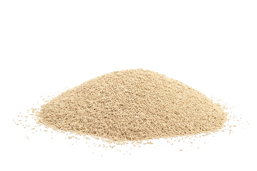 A pile of dried baking yeast, isolated on a white background.