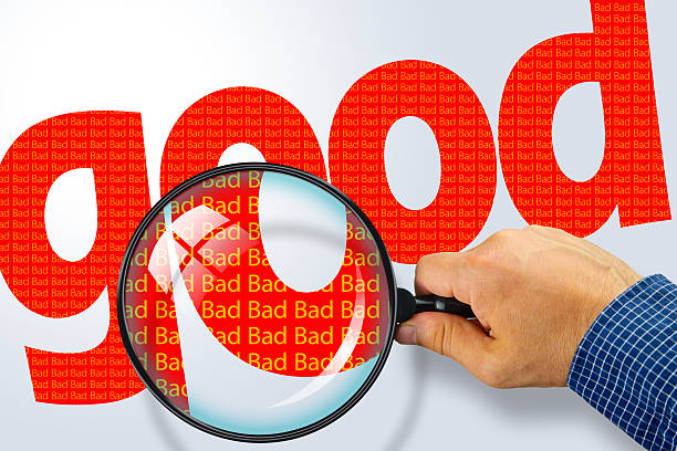 istock GOOD - BAD Opposite message, Hand holding magnifying glass 480715380