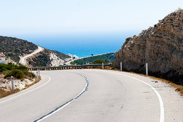istock Turning mountain highway with blue sky and sea 480720894