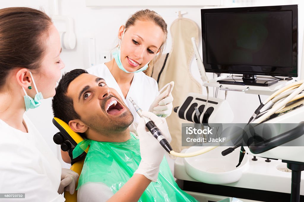 Patient checking the teeth Man patient checking the teeth on computer equipment 20-29 Years Stock Photo