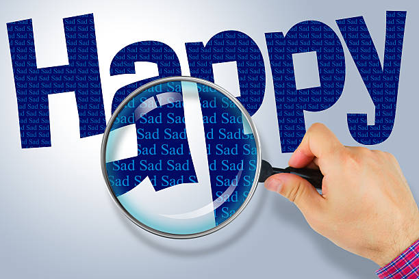istock HAPPY - SAD Opposite message, Hand holding magnifying glass 480724128