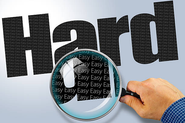 istock HARD - EASY Opposite message, Hand holding magnifying glass 480724130